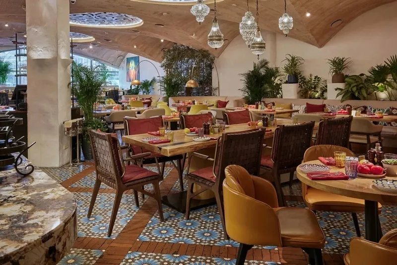 Restaurant hall with patterned tiles and a timber vaulted ceiling